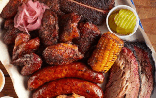 A barbecue platter with smoked meats and sausages