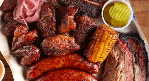 A barbecue platter with smoked meats and sausages