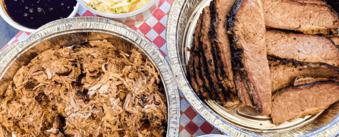 A tablecloth covered with various dishes including barbecue and sauces