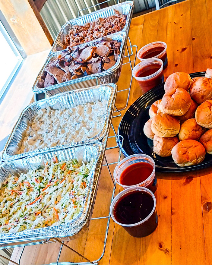 Assorted BBQ platter with multiple smoked meats and sides for catering in Eagan, MN