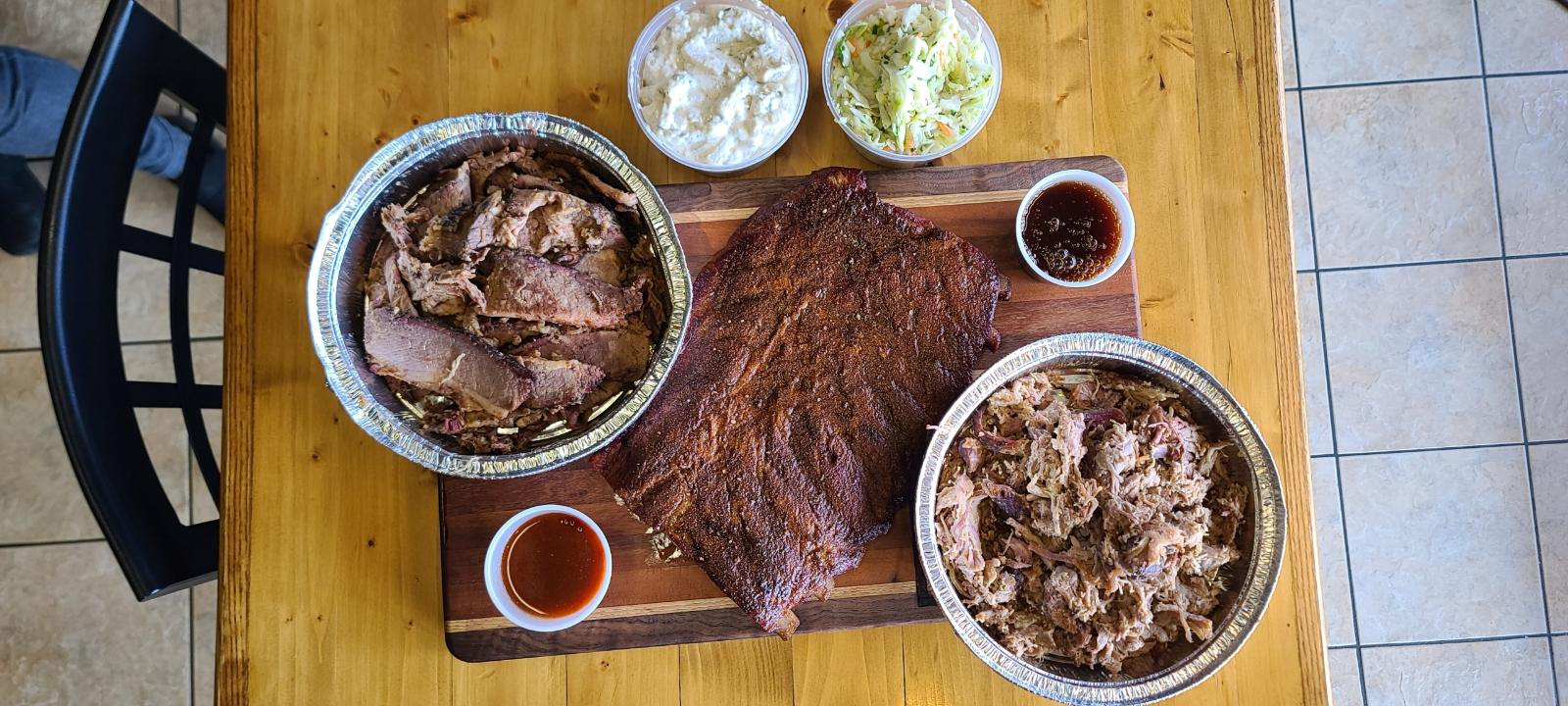 Platter of smoked meats, vegetables, and gluten-free sides