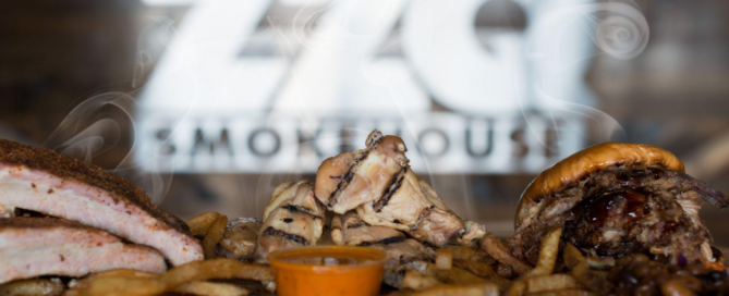 A barbecue platter with ribs, fries, and a burger from ZZQ Smokehouse.