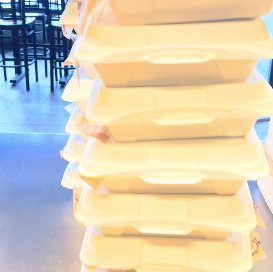 a pile of boxed BBQ lunches