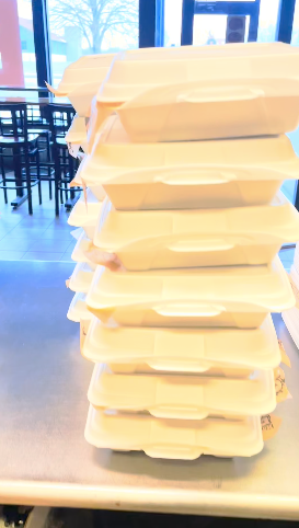 a pile of boxed BBQ lunches